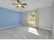 A spacious bedroom features plush carpeting, ceiling fan, and large window at 3447 Nadasky Ave, North Port, FL 34288
