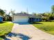 A single-story home with a manicured lawn and a two-car garage at 3447 Nadasky Ave, North Port, FL 34288