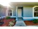 Close-up view of the front door with decorative landscaping and arched windows at 3447 Nadasky Ave, North Port, FL 34288