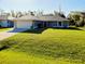 Charming home with a well-manicured lawn and a two-car garage at 3447 Nadasky Ave, North Port, FL 34288