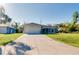 A one-story home with a two-car garage and a well-kept lawn at 3447 Nadasky Ave, North Port, FL 34288