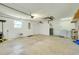 Clean and spacious two-car garage featuring laundry area, water heater, and side door access at 3447 Nadasky Ave, North Port, FL 34288