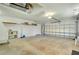 Spacious two-car garage with overhead storage, shelving, and ample room for vehicles and projects at 3447 Nadasky Ave, North Port, FL 34288