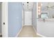 Neutral hallway with tiled flooring and views to other rooms of the house at 3447 Nadasky Ave, North Port, FL 34288