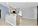 Bright kitchen with stainless appliances, stylish countertops, and a kitchen island bar at 3447 Nadasky Ave, North Port, FL 34288