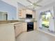 Updated kitchen features stainless steel appliances, tile floors, and a bright window at 3447 Nadasky Ave, North Port, FL 34288