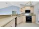 Updated kitchen featuring stainless appliances, light wood cabinets, and an open layout at 3447 Nadasky Ave, North Port, FL 34288