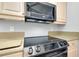 A modern kitchen features stainless steel appliances and light wood cabinetry at 3447 Nadasky Ave, North Port, FL 34288