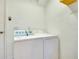Bright laundry room with white appliances, providing convenience and efficiency for household chores at 3447 Nadasky Ave, North Port, FL 34288