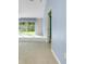 Bright living room featuring tile floors and sliding glass doors to the backyard at 3447 Nadasky Ave, North Port, FL 34288