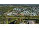 Beautiful aerial view of a landscaped property with a pool, lush greenery, and surrounding neighborhood, highlighting community charm at 358 Pineview Dr, Venice, FL 34293