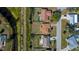 Overhead view of a residential neighborhood featuring homes and a verdant canal at 358 Pineview Dr, Venice, FL 34293