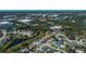 Wide aerial shot of a community with houses, canals, and commercial areas visible at 358 Pineview Dr, Venice, FL 34293