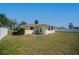 Back yard featuring a lawn with fresh landscaping around the home at 358 Pineview Dr, Venice, FL 34293