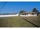 Back yard featuring a full lawn surrounded by a privacy fence at 358 Pineview Dr, Venice, FL 34293