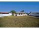 Spacious backyard view of a single-story home with a well-maintained lawn and a white fence at 358 Pineview Dr, Venice, FL 34293