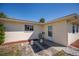 Backyard with tan colored home, a door and a hose hanging on the wall at 358 Pineview Dr, Venice, FL 34293