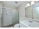 Bathroom featuring a glass shower, white tile, and updated sink and vanity at 358 Pineview Dr, Venice, FL 34293