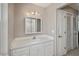 Bathroom with a single sink vanity, large mirror, and ample cabinet space at 358 Pineview Dr, Venice, FL 34293