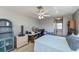 This bedroom view features a ceiling fan, closet, and a work space at 358 Pineview Dr, Venice, FL 34293