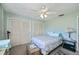 Spacious bedroom with a ceiling fan, two closets and light green walls at 358 Pineview Dr, Venice, FL 34293