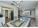 Bright dining room featuring a glass table, tile flooring, and a view of the neighborhood at 358 Pineview Dr, Venice, FL 34293