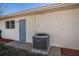 Exterior side view of home with access door, mulch bed, and AC unit at 358 Pineview Dr, Venice, FL 34293