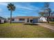 Charming single-story home with a well-manicured lawn and a driveway leading to an attached garage at 358 Pineview Dr, Venice, FL 34293