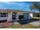 Close up of the front exterior with covered entryway, garage door, and well maintained landscaping at 358 Pineview Dr, Venice, FL 34293