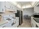 Efficient kitchen boasts white cabinetry, appliances and a view into the dining room at 358 Pineview Dr, Venice, FL 34293