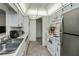 Bright kitchen featuring white cabinets, modern appliances, and tile flooring at 358 Pineview Dr, Venice, FL 34293