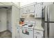 Well-maintained kitchen features white cabinetry and newer appliances, with functional layout at 358 Pineview Dr, Venice, FL 34293