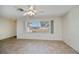 Living room with ceiling fan and large window providing outdoor views at 358 Pineview Dr, Venice, FL 34293