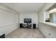 Living room features tile floors, neutral walls, and a pass-through to the kitchen at 358 Pineview Dr, Venice, FL 34293