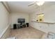 Bright living room features tile flooring, neutral colors, and a view of the kitchen at 358 Pineview Dr, Venice, FL 34293