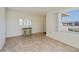 Open-concept living room with neutral tile flooring and a charming blue cabinet at 358 Pineview Dr, Venice, FL 34293