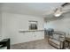 Living room view features tile floors, neutral paint, and pass through to kitchen and dining area at 358 Pineview Dr, Venice, FL 34293