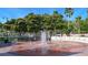 Charming town fountain surrounded by brick walkways, benches, and lush greenery creating a peaceful public space for residents at 358 Pineview Dr, Venice, FL 34293