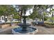 Classic tiered water fountain in a park setting, surrounded by benches, trees, and greenery providing a peaceful environment at 358 Pineview Dr, Venice, FL 34293