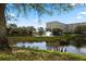 Scenic view of a lush pond with a fountain and ducks in a beautiful, well-maintained community at 3730 Cadbury Cir # 429, Venice, FL 34293