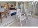 Relax on the tiled balcony with white chairs off the bedroom area in this condo at 418 Cerromar Ct # 261, Venice, FL 34293