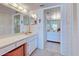 Bright bathroom featuring a double vanity, well-lit mirrors and neutral decor at 418 Cerromar Ct # 261, Venice, FL 34293