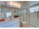 Bathroom featuring a shower with glass doors, vanity, and coordinated decor at 418 Cerromar Ct # 261, Venice, FL 34293