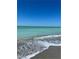 Serene beach scene with gentle waves and clear blue water at 418 Cerromar Ct # 261, Venice, FL 34293