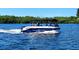 Boating on clear water with blue sky and a pontoon boat full of people for coastal living at 418 Cerromar Ct # 261, Venice, FL 34293