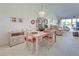 Open dining area featuring contemporary chandelier and sliding doors to balcony at 418 Cerromar Ct # 261, Venice, FL 34293