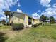 Well-maintained condo building with lush landscaping and mature palm trees at 418 Cerromar Ct # 261, Venice, FL 34293
