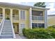 Attractive two-story condo featuring shuttered windows, and a private screened in porch at 418 Cerromar Ct # 261, Venice, FL 34293