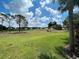 Picturesque view of the golf course surrounded by lush green grass and mature trees at 418 Cerromar Ct # 261, Venice, FL 34293