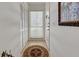 Foyer area with decorative rug, storage closet, and natural light by the entry door at 418 Cerromar Ct # 261, Venice, FL 34293
